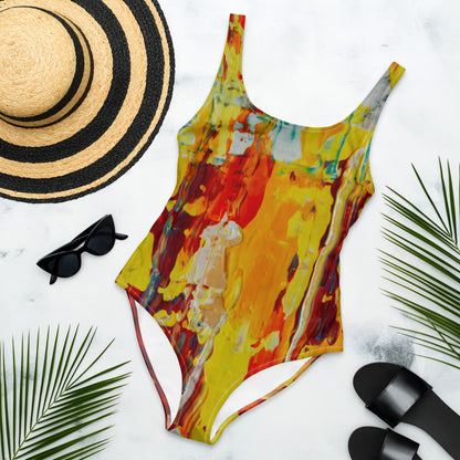 One-piece swimsuit printed in yellow, orange and red, with a cheeky cut and lined front.