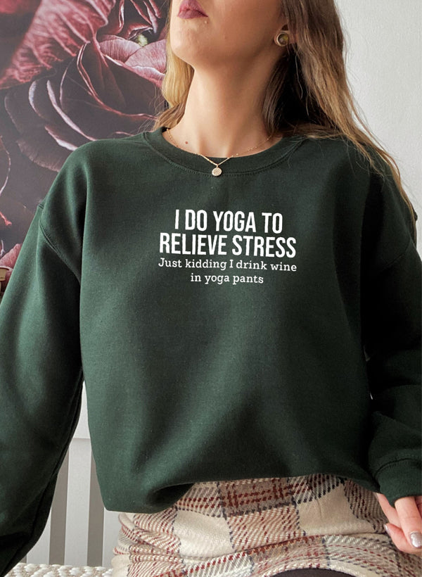 Forest green cotton fleece crewneck worn by a model, yoga slogan on the chest.