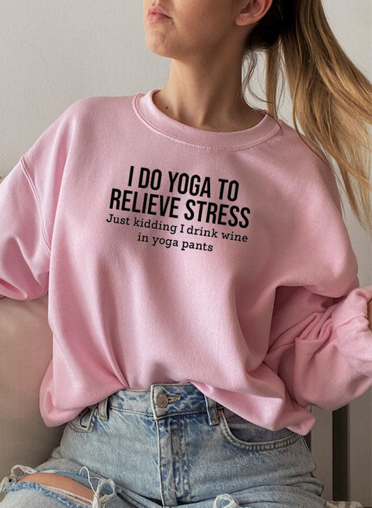 Pink cotton fleece crewneck, yoga slogan printed across the chest.