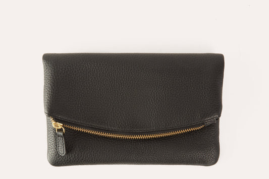 Black pebbled leather fold over clutch with a gold-tone zip running across the fold, front view
