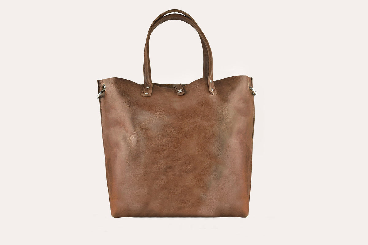 Caramel brown smooth leather tote bag with two top handles and silver-tone rivets, front view