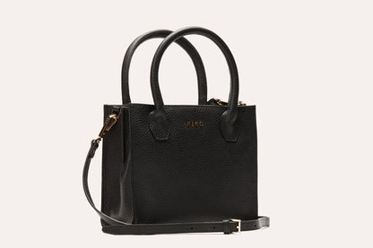 Black pebbled leather mini tote crossbody bag with two rolled top handles and its long strap attached