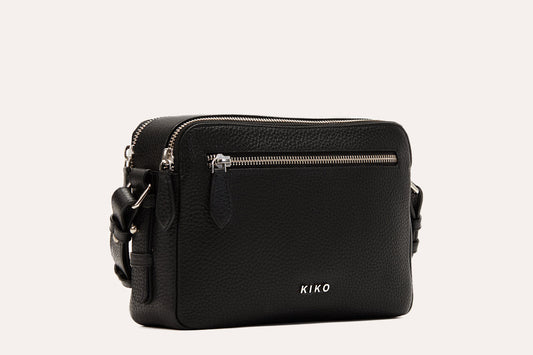 Black pebbled leather camera crossbody bag with two top zips and a front zip pocket, silver-tone hardware