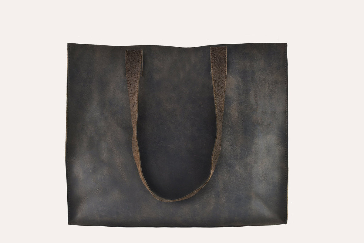 Dark brown marbled leather tote bag with two flat handles and raw cut edges, front view