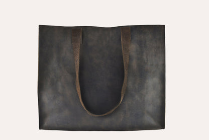 Dark brown marbled leather tote bag with two flat handles and raw cut edges, front view