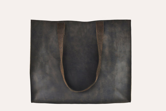 Dark brown marbled leather tote bag with two flat handles and raw cut edges, front view