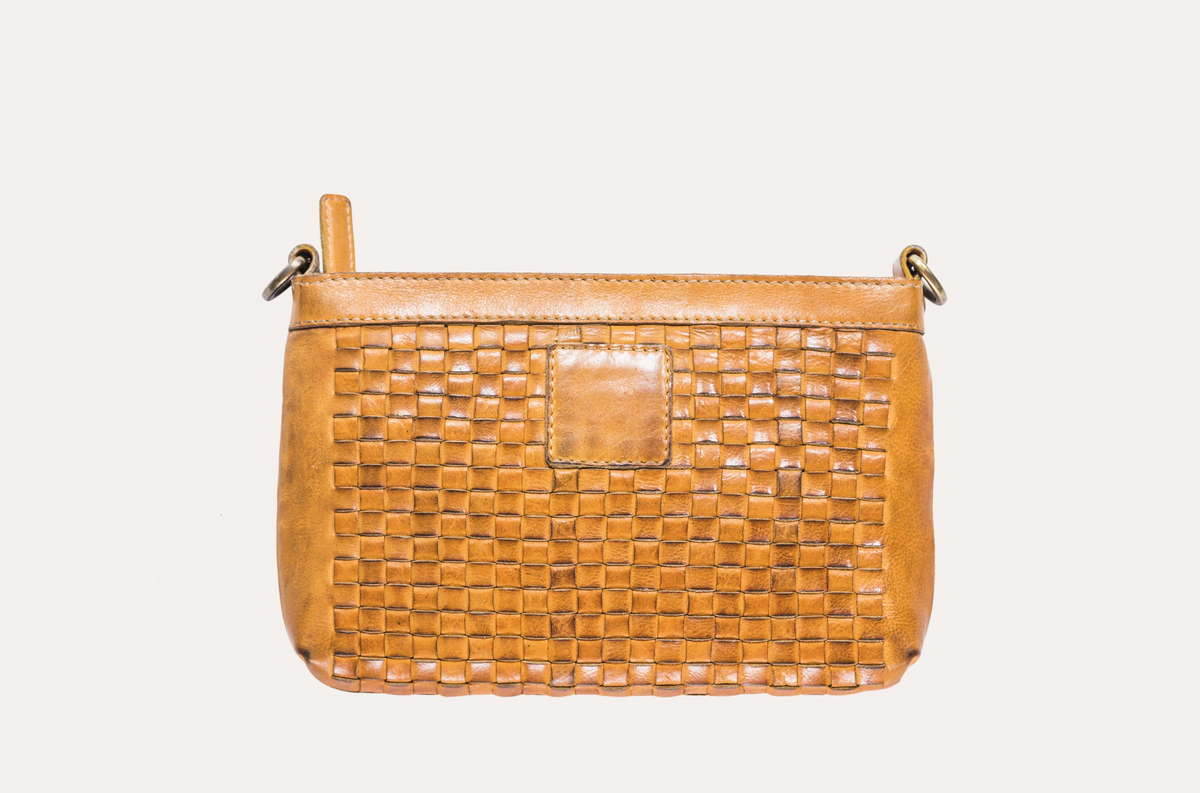 Tan woven leather crossbody bag with a top zip and a smooth leather patch on the front, front view