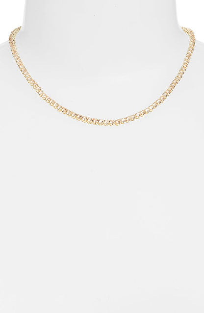 Topaz tennis necklace on a white bust form, a continuous line of champagne colored stones