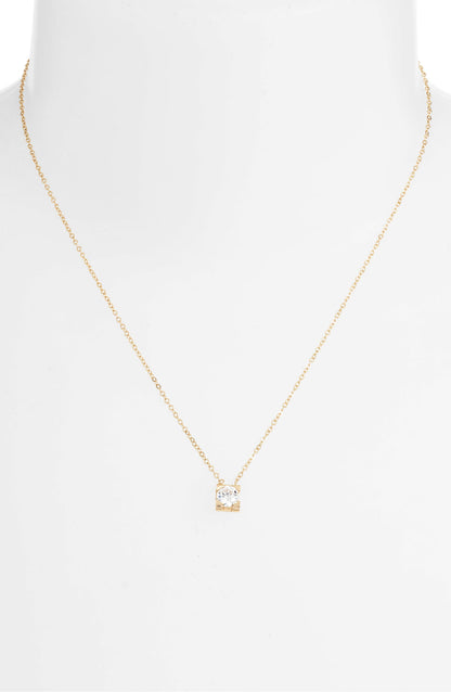 CZ solitaire necklace on a white bust form, the small square pendant resting below the collarbone