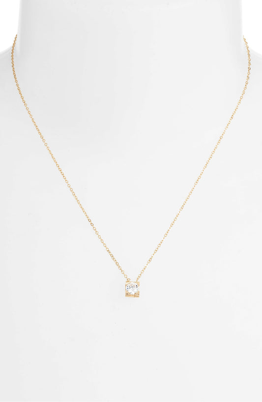 CZ solitaire necklace on a white bust form, the small square pendant resting below the collarbone