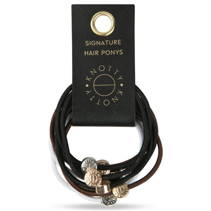 Hair tie bracelets in black, white and brown with metal beads, looped on a black branded leather tab