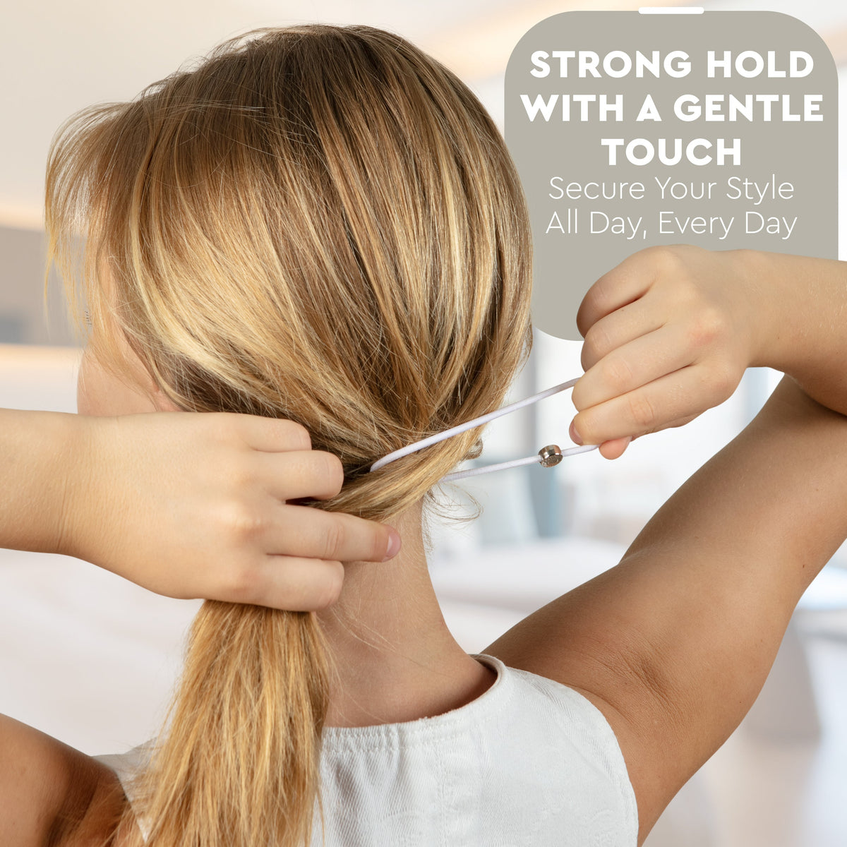 Model seen from behind tying a white hair tie around a low ponytail, with promo text