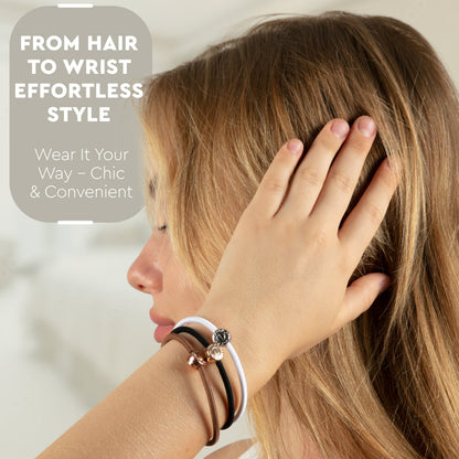 Model with black, white and brown hair ties worn as bracelets on her wrist