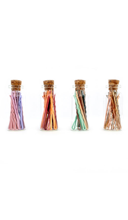 Corked glass canisters of mini bobby pins in pastel, coral, mint and metallic colorways