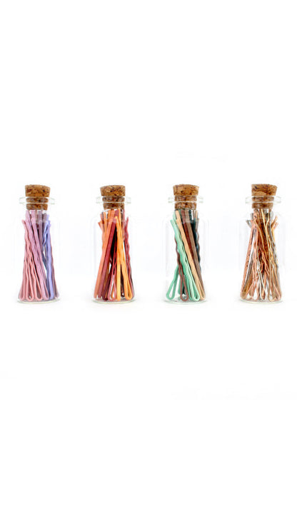 Corked glass canisters of mini bobby pins in pastel, coral, mint and metallic colorways