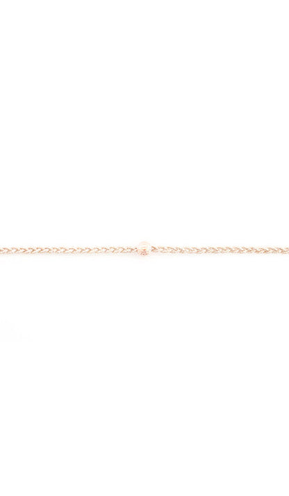 Rose gold braided headband up close, showing the twist of the cord and the bead