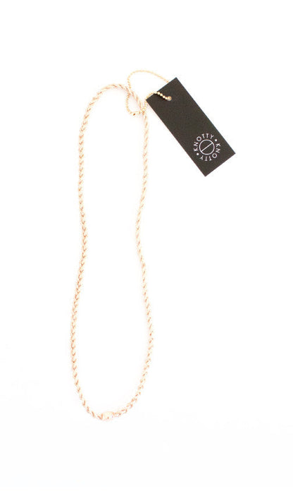 Rose gold braided metallic stretch headband shown full length on white