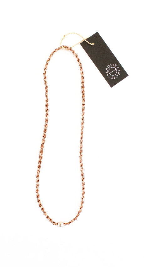 Bronze braided metallic headband shown full length on white with its tag