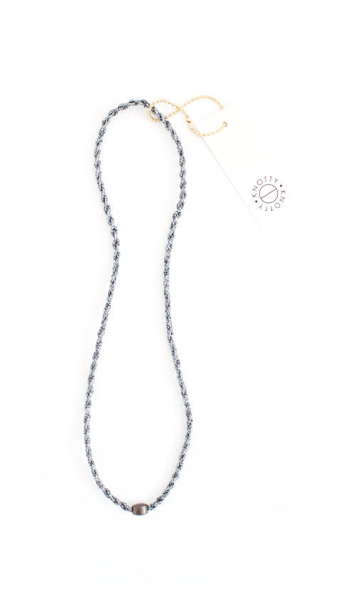 Gunmetal braided headband in dark silver tones with a polished bead, full length