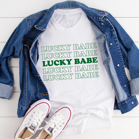 White cotton graphic T-shirt featuring a Lucky Babe design on the front.