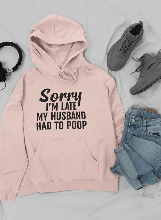 Heather Prism Peach hoodie laid flat with jeans, sneakers and headphones, slogan in black.
