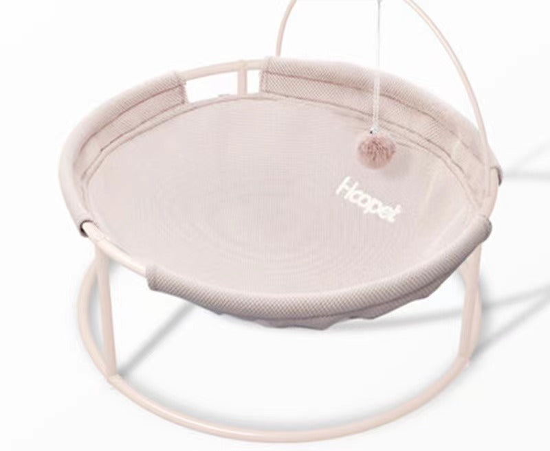 Beige hammock cat bed on a metal frame.