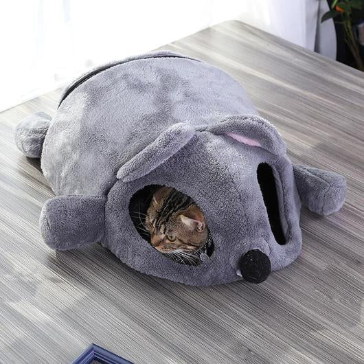 Tabby cat lying inside the grey mouse shaped cave bed.