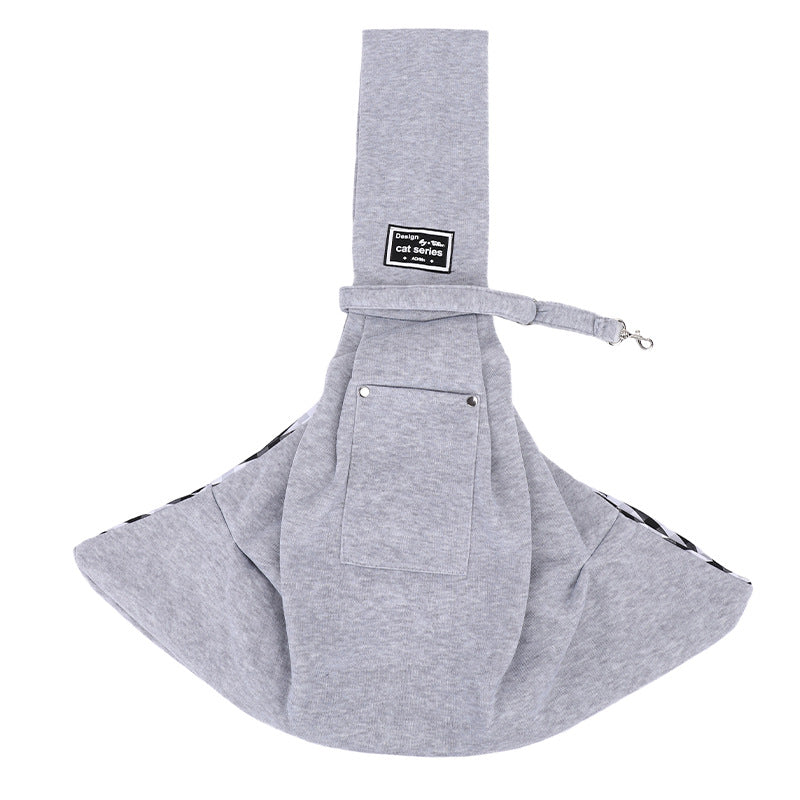 Grey pet sling carrier laid flat with the shoulder strap across the top.