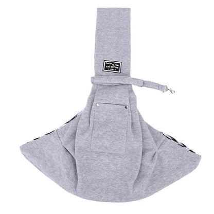 Grey pet sling carrier laid flat with the shoulder strap across the top.