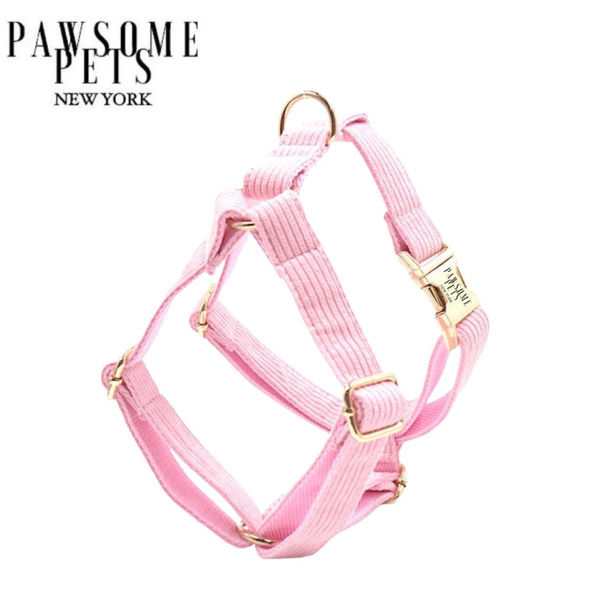 Baby pink step-in dog harness in printed polyester webbing with metal fittings.