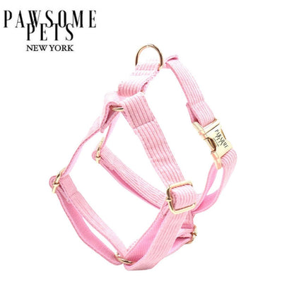 Baby pink step-in dog harness in printed polyester webbing with metal fittings.