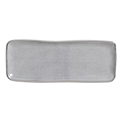 The bare gray platter at an angle, showing its shallow rise and rounded corners.