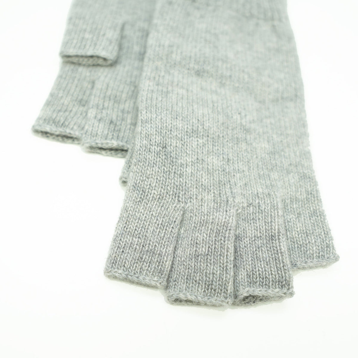 Close up of the open fingertips and thumb on light gray cashmere fingerless gloves