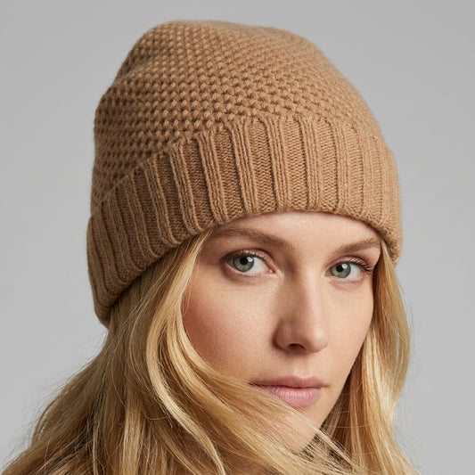 Light camel cashmere beanie on a model, honeycomb stitch above a ribbed fold-up cuff