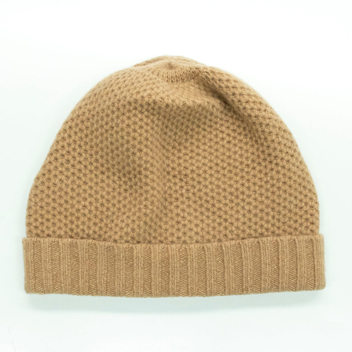 Light camel honeycomb cashmere beanie laid flat with its ribbed cuff folded up