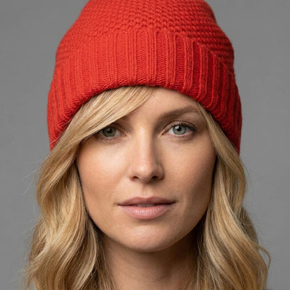 Fire red honeycomb cashmere beanie worn straight on, cuff folded at the brow