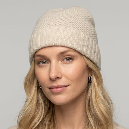 White colorway on a model, a soft creamy white honeycomb knit with ribbed cuff