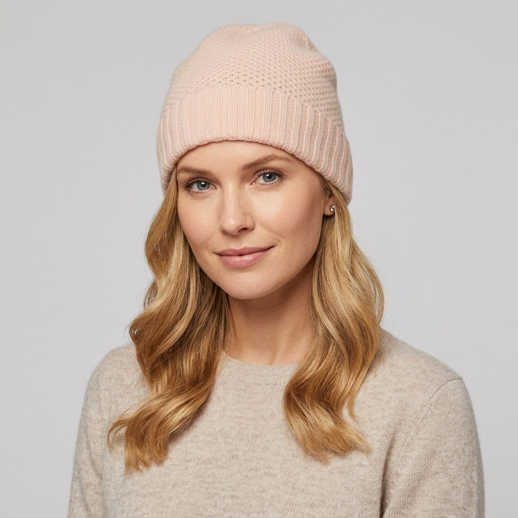 Rose quartz cashmere beanie on a model, a pale pink honeycomb knit with ribbed cuff