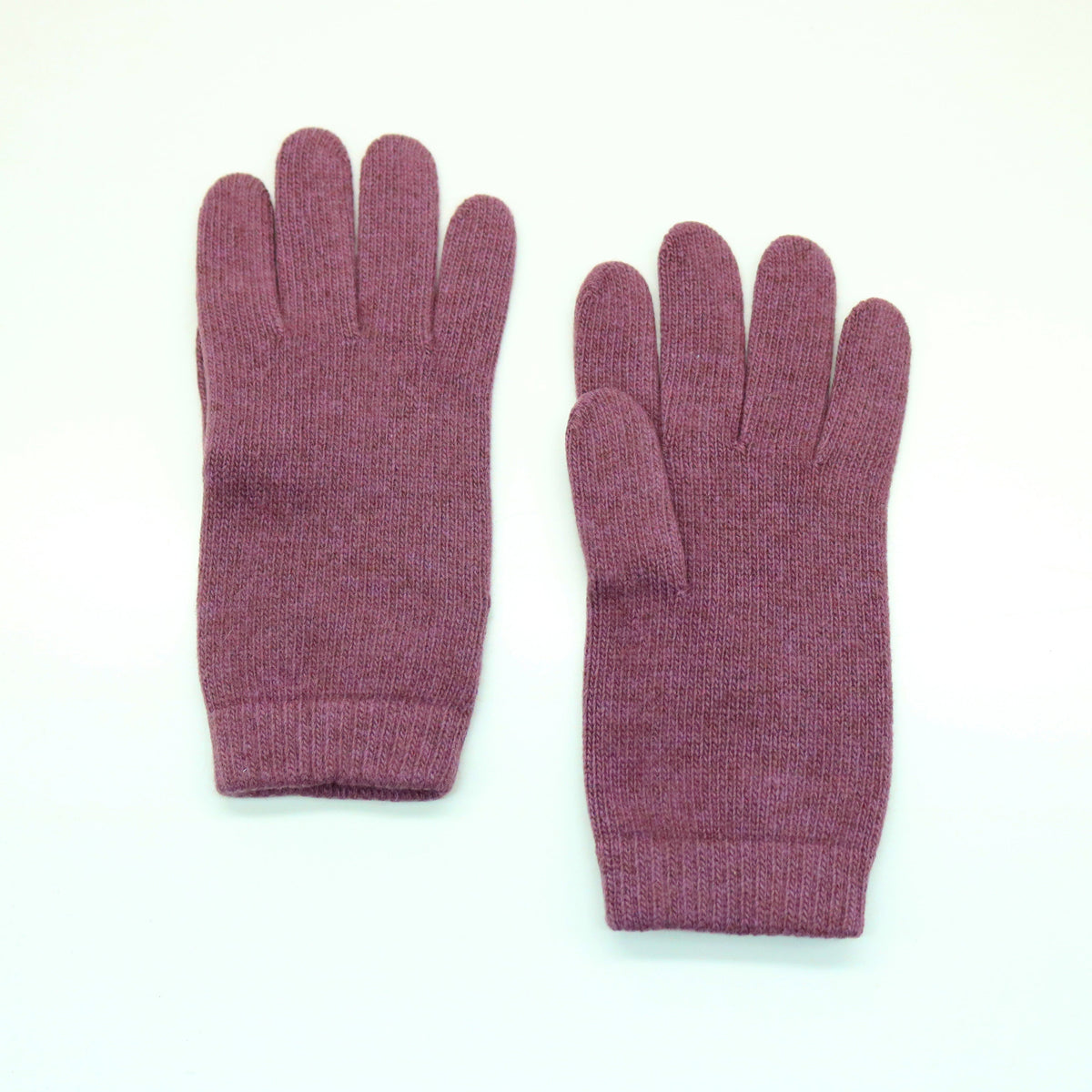 Dusty rose cashmere gloves laid flat with ribbed cuffs