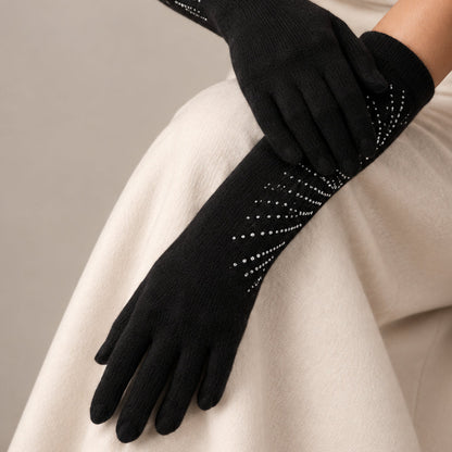 Black long cashmere gloves with rhinestone rays worn by a model in cream