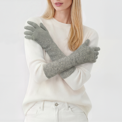 Model in a white sweater wearing light gray long cashmere gloves with rhinestones