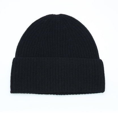 Black ribbed cashmere hat laid flat, cuff turned back