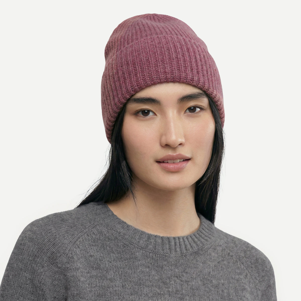 Model in the dusty rose ribbed cashmere hat, a muted berry pink