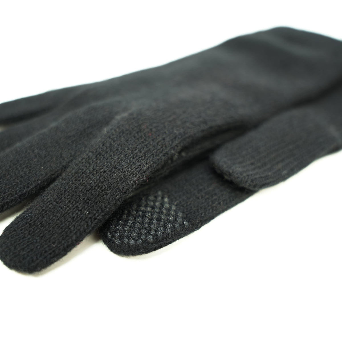 Close up of the touchscreen pads on the fingertips of black cashmere gloves