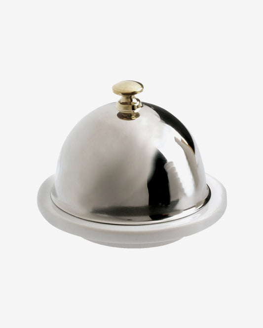 Round white porcelain butter dish under a polished stainless steel dome with a small knob.