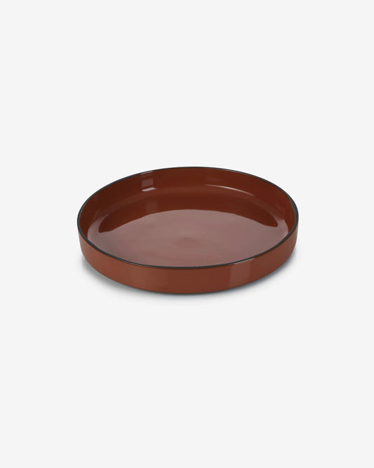 Cinnamon deep plate seen at an angle, showing the straight wall of its rim.