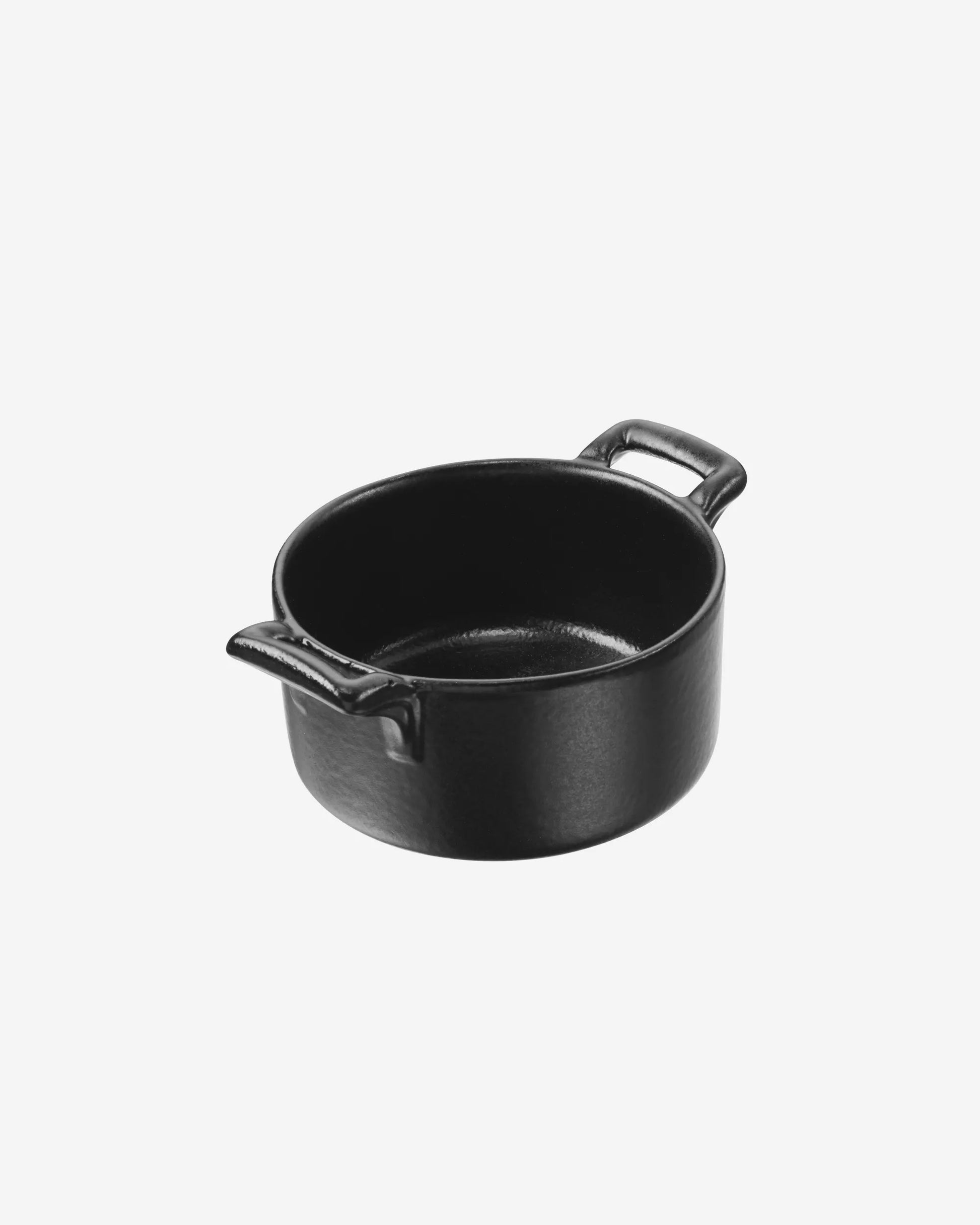Small black dish with two side handles, photographed alone on a pale ground.
