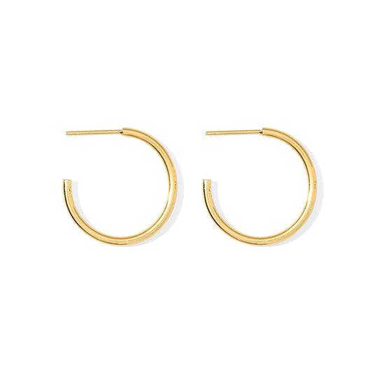 Small gold plated hoop earrings, a slim round tube hoop about 1 inch across, front and side view on white