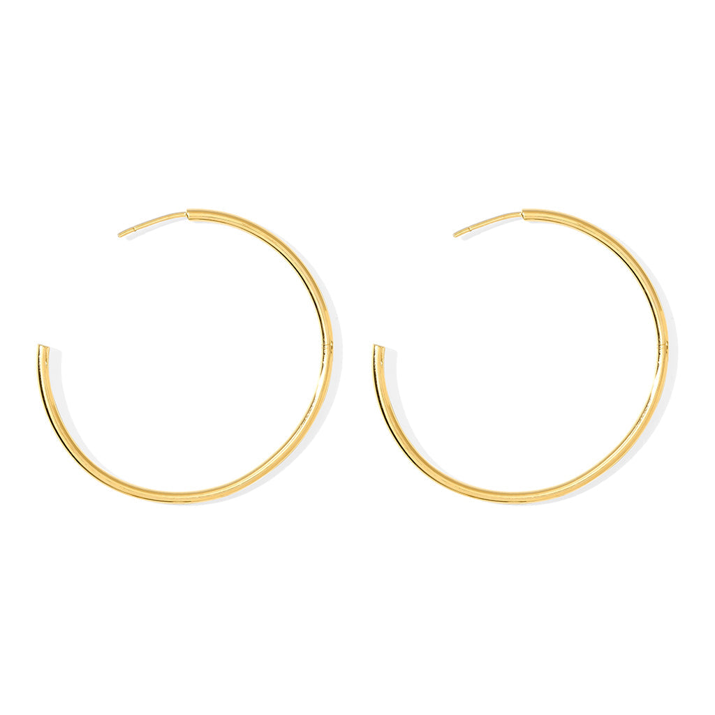 Large gold plated hoop earrings, 1.8 inches across, a pair of thin round open hoops on white
