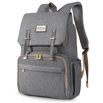 Gray canvas diaper backpack with leather straps and a bottle in the side pocket.